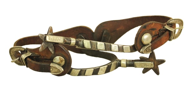 Cowboy used pair of single mounted McChesney's with silver striped bands and period straps.