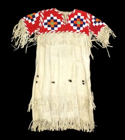 Northern Plains beaded buckskin dress with extensively beaded yoke of terrific colors on red
