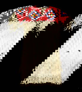 Northern Plains beaded buckskin dress with extensively beaded yoke of terrific colors on red: Northern Plains beaded buckskin dress with extensively beaded yoke of terrific colors on red background, accented by fringe and cones.