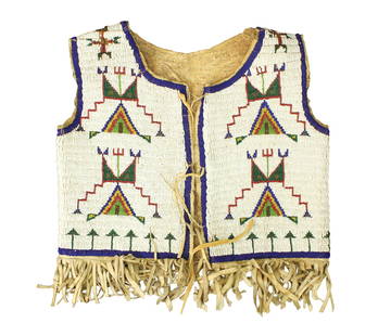 Fabulous fully beaded turn-of-the-century vest on hide, with outstanding geometric design on white: Fabulous fully beaded turn-of-the-century vest on hide, with outstanding geometric design on white background, accented by great fringed bottom.