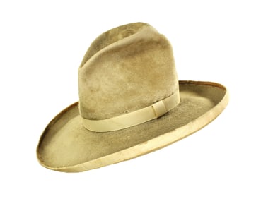 Striking early cowboy hat, of appealing nutria in natural color, with 3/4" silk band and bound edge.