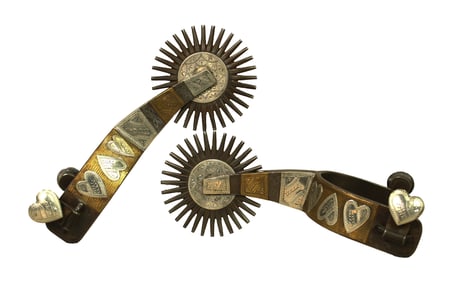 Massive pair of double mounted spurs by a desirable maker, done in a four heart pattern with silver