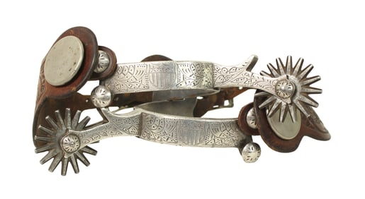 A phenominal pair of excedingly rare spurs, single mounted with a full overlaid sheild pattern,