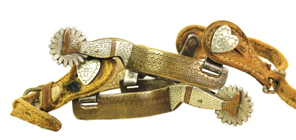 An interesting pair of lady leg spurs from a very scarce maker, with uniquely engraved brass and