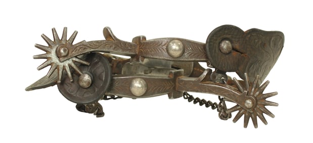Scarce pair of large Bronco Buster pattern spurs with artistically engraved iron complimented by