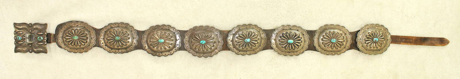 Large Native American silver concho belt with 8 mounded  3 3/4" scalloped conchos centered with: Large Native American silver concho belt with 8 mounded 3 3/4" scalloped conchos centered with tuqiouse stones all mounted on leather, and finished with a wonderful decoratively shaped rectangular buc