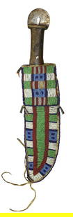  Northern Plains Beaded Knife Sheith : Large Blackfoot beaded knife sheath with wonderful full coverage pattern of early beads, completed by a great knife that incorperates a hide scraper into the end of the handle. Sheath measuring 11"x 3