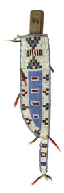 Showing a design of unique colors, this Sioux Indian knife sheath is fully beaded, accented with