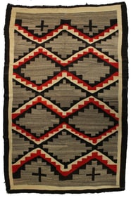 A nicely sized rug patterned with verigated diamonds and Mission Crosses, measuring 56"x 86".