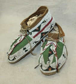 Wonderful large Northern Plains moccasins, fully beaded with uncommon green focal color, biforcated