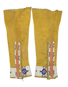 Mens size 19th century Native American hide leggings, displaying great yellow ochre color, and
