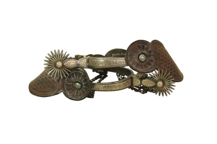 Classy pairof single mounted Buerman spurs with great engraving, shaped shanks, dazzling multi-point