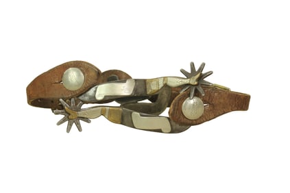 Nicely presenting single mounted brass and silver lady leg spurs with oversized strap buttons, and