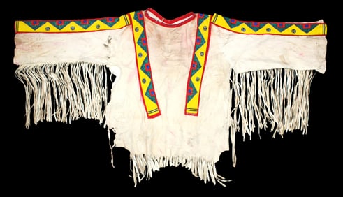 An eye catching vintage Northern Plains hide shirt with applied beaded strips and extensive long