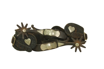 Pleasing Texas style single mounted spurs with heart buttons, sweeping chapgaurds and large nine