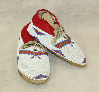 Pleasing pair of mens size fully beaded Plains Indian moccasins with a serrated bead pattern on: Pleasing pair of mens size fully beaded Plains Indian moccasins with a serrated bead pattern on white background. In very nice condition.