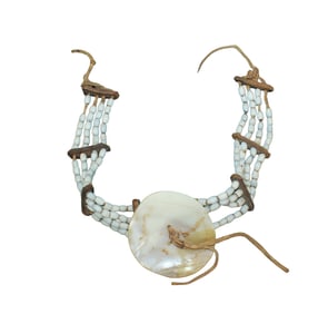 An extra appealing Northwest necklace nicely done wiith shell beads on buckskin with harness leather