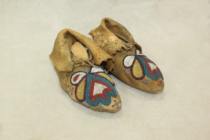 An attractive pair of beautifully beaded childs moccasins, with an interesting pattern and large