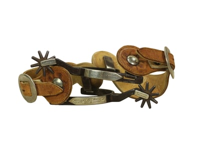 An excellent condition pair of single mounted spurs with nice appeal, uncommon shank maker marks and