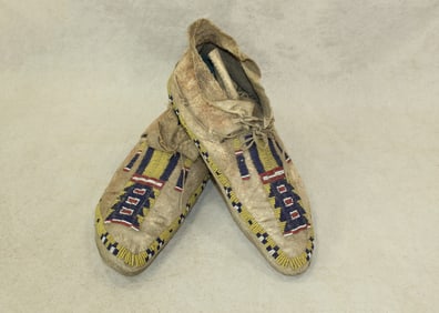 An extra nice pair of Northern Plains beaded moccasins, beaded on brain tanned hide, with