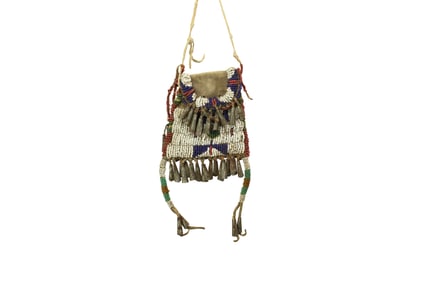 A wonderful 19th century beaded strike-a-lite bag, on hide with great beadwork, decorative drops,