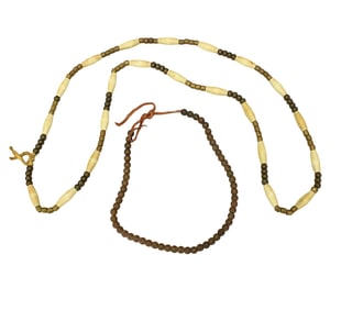 A pair of Native American necklaces, showing hairpipe bone and copper beads strung on hide.