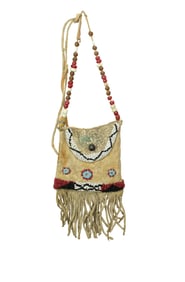 Very attractive brain tanned hide bag with appealing beadwork and decorative fringe. Dimensions 7