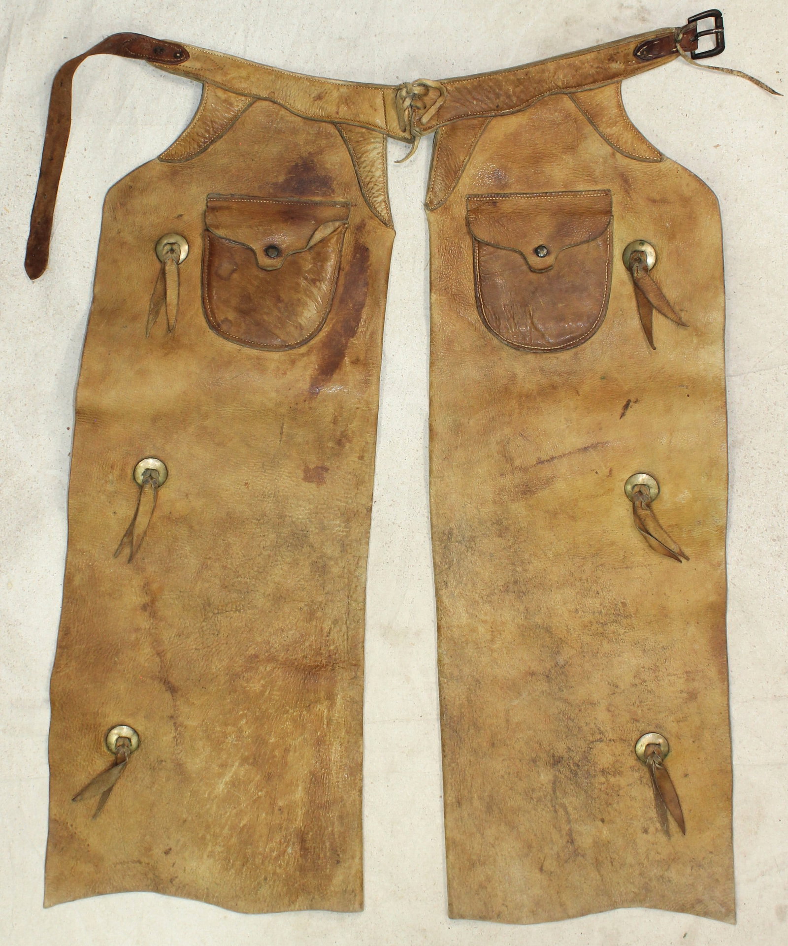 Childs R.T. Frazier Chaps: A handsome pair of two-tone shotgun style chaps with batwing appearance, accented by exterior pockets and conchos, and maker marked belt.