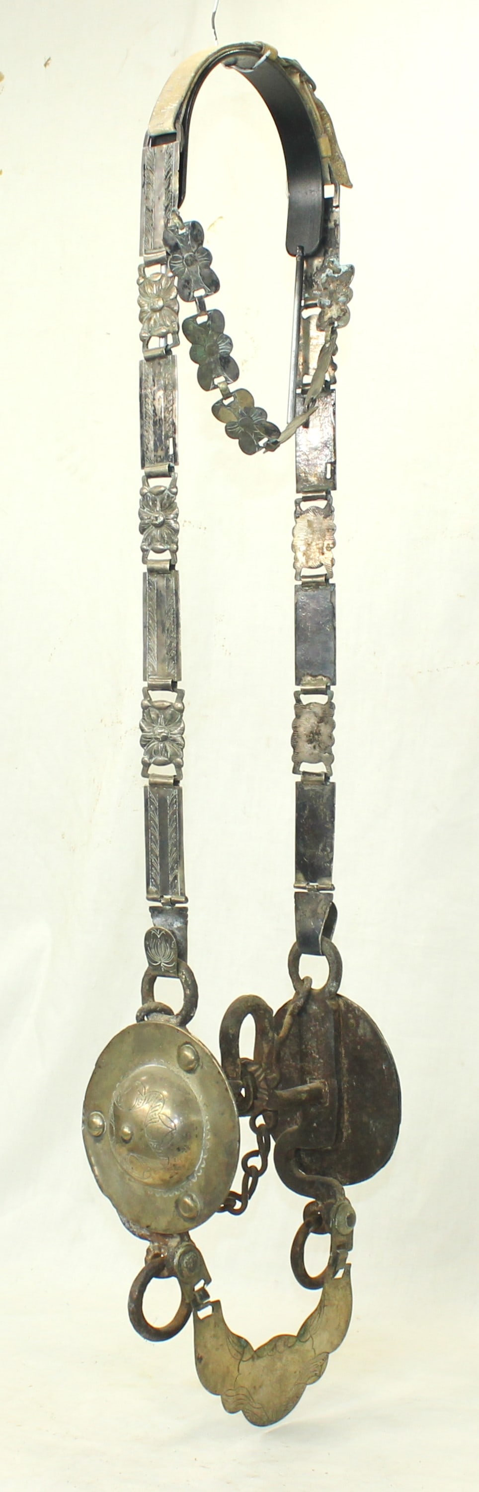 Argentine Silver Bridle: Eye catching massive Argentine silver-mounted headstall displaying extra large engraved bit and cheek pieces, accompanied by a finely silver mounted headstall. Features floral silver decorations throu