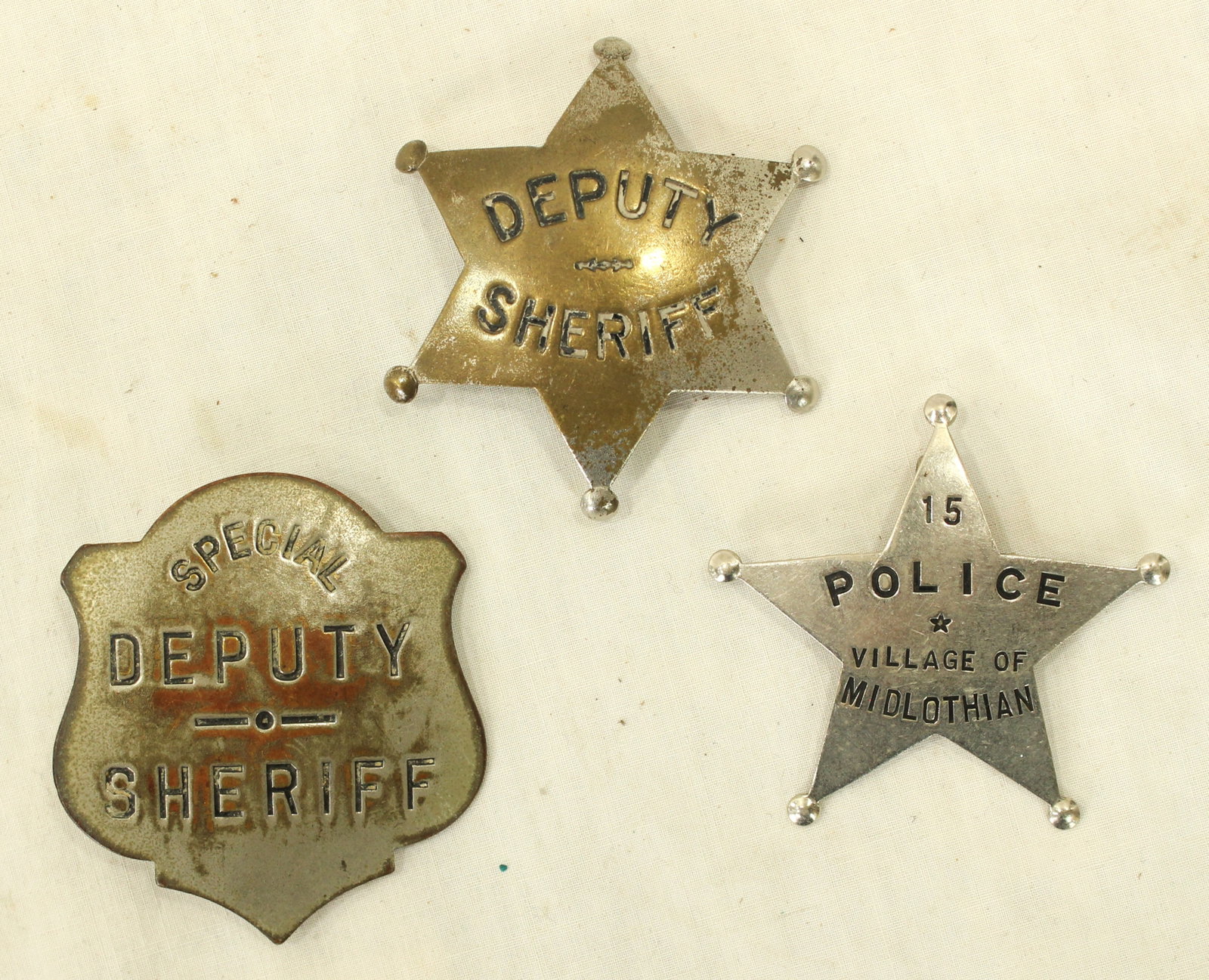 Lot of 3 Antique Badges: Collection of three vintage law enforcement badges including Deputy Sheriff, Special Deputy Sheriff, and Village of Midlothian Police examples. Mixed construction and periods. Interesting group for