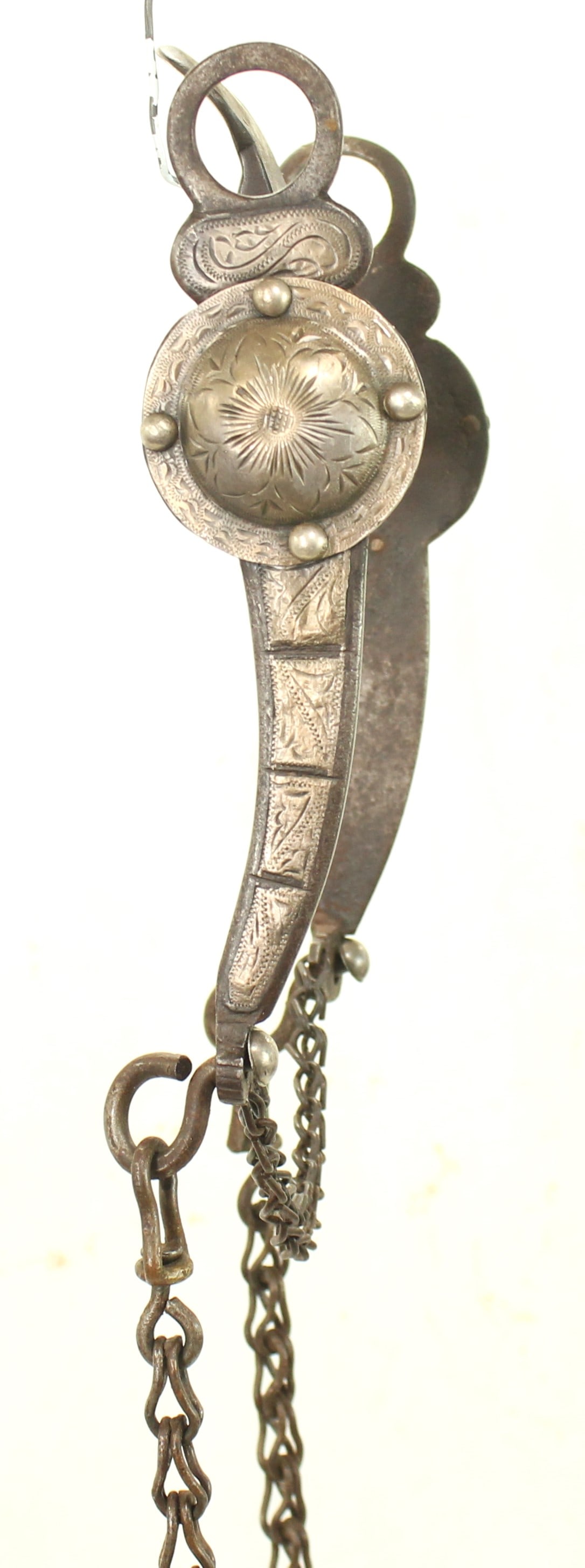 California Spade Bit: Ornate Western bit embellished with engraved silver overlays and decorative mountings, with a pleasing tall spade mouth piece, and rein chains. Featuring attractive floral engraving and pleasing age