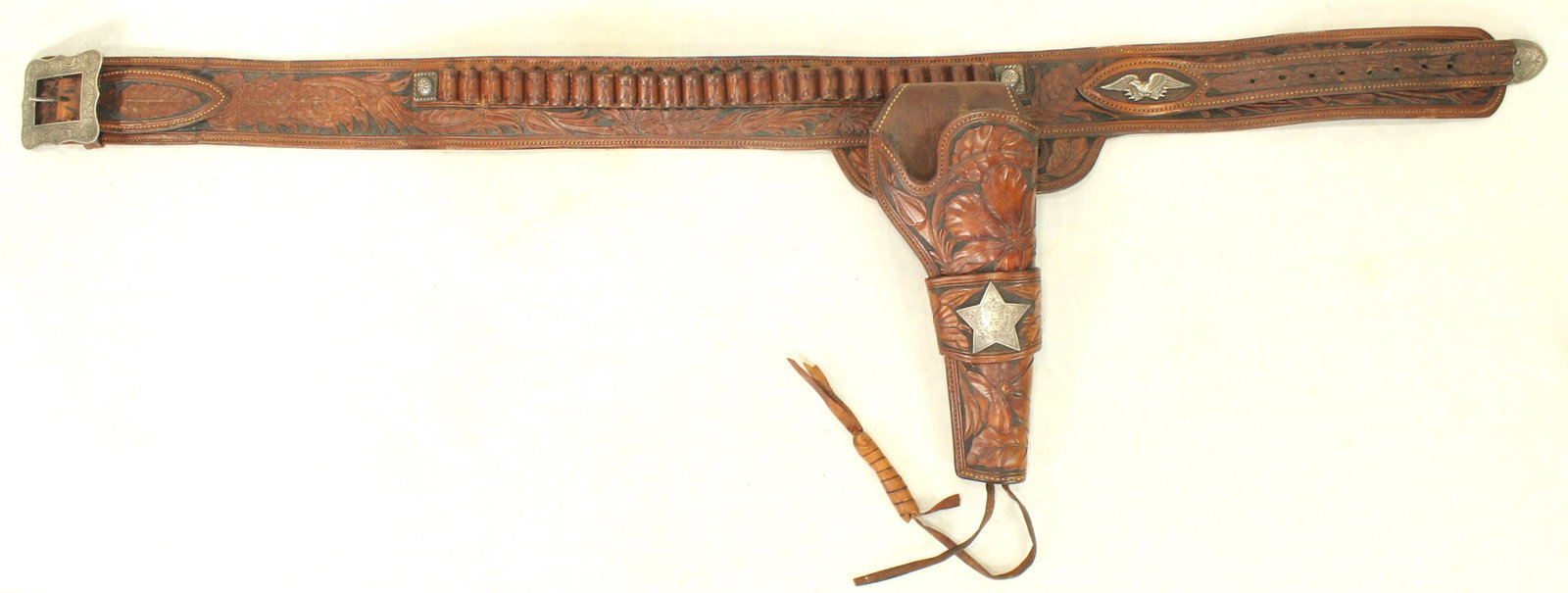 Visalia Tooled Gun Rig: Impressive carved leather cartridge belt complete with matching holster for a 7 ½” Colt single action.