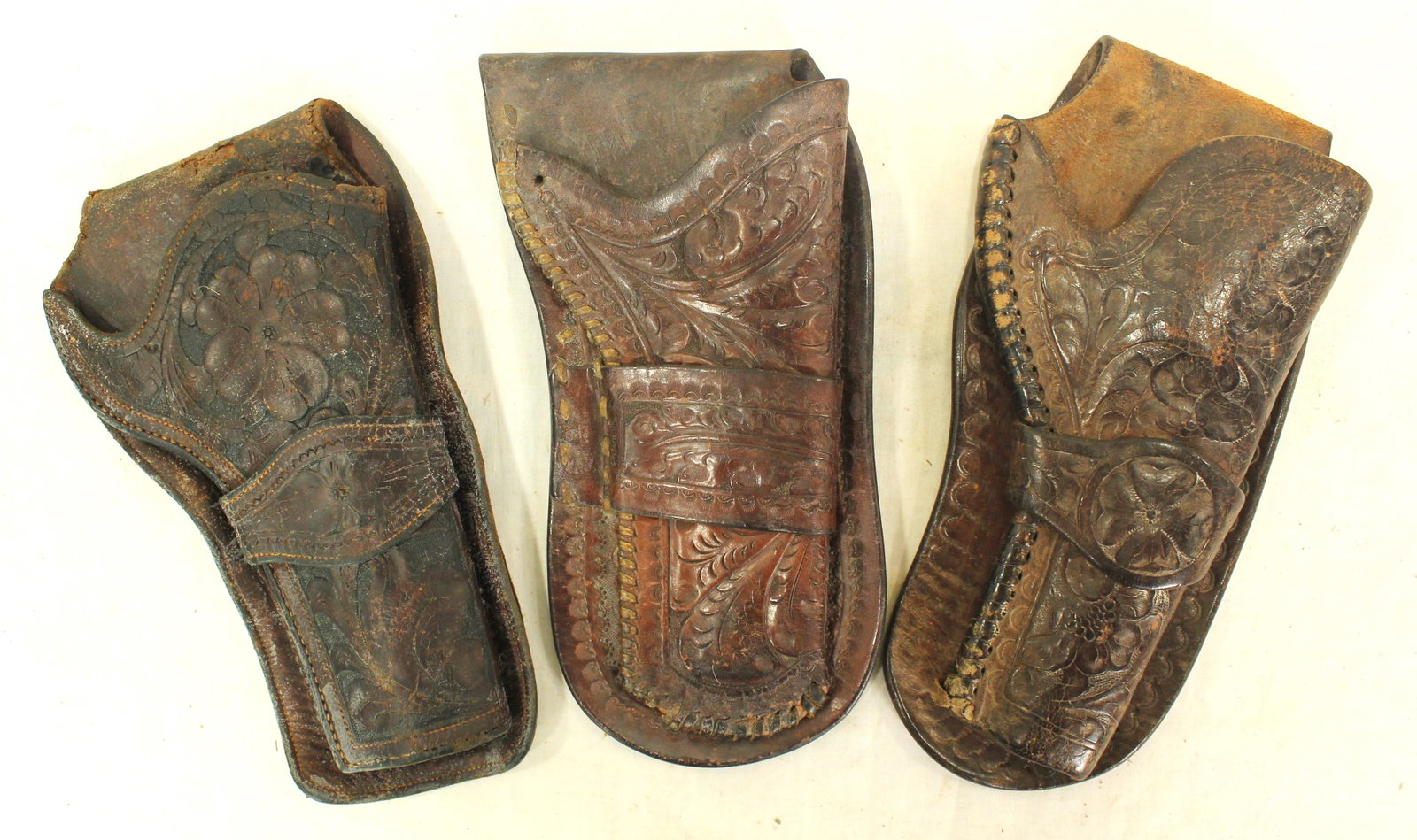 Lot of 3 Al Furstnow Holsters: Three seldom seen holsters from this desirable Miles City maker, all single loop 4 ¾” Colt single action holster with appealing flower tooled patterns.