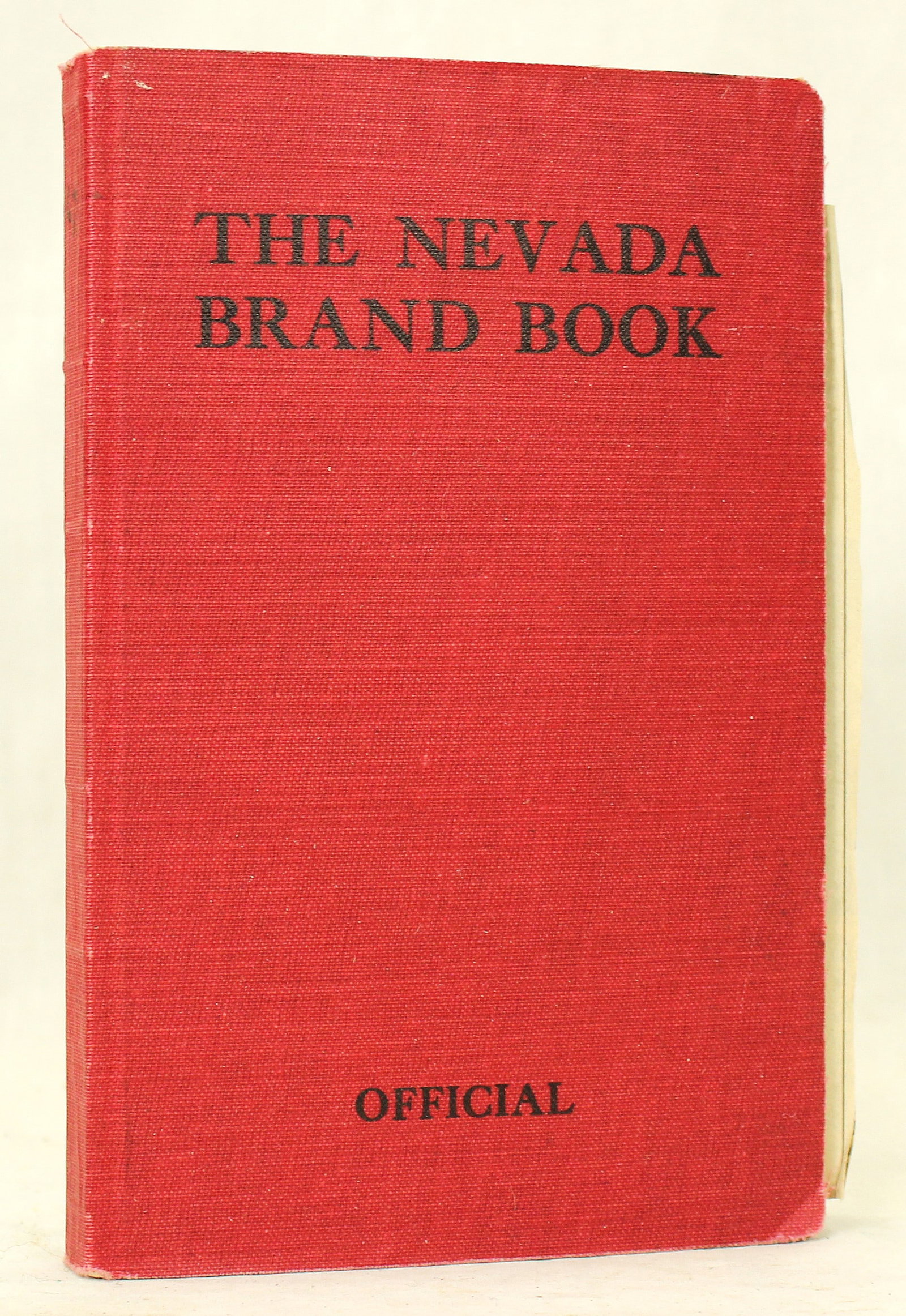Nevada Brand Book: Official Nevada livestock brand book documenting registered cattle and horse brands throughout the state. Bound in its original red cloth cover, is displays a very crisp interior, and is in overall ve