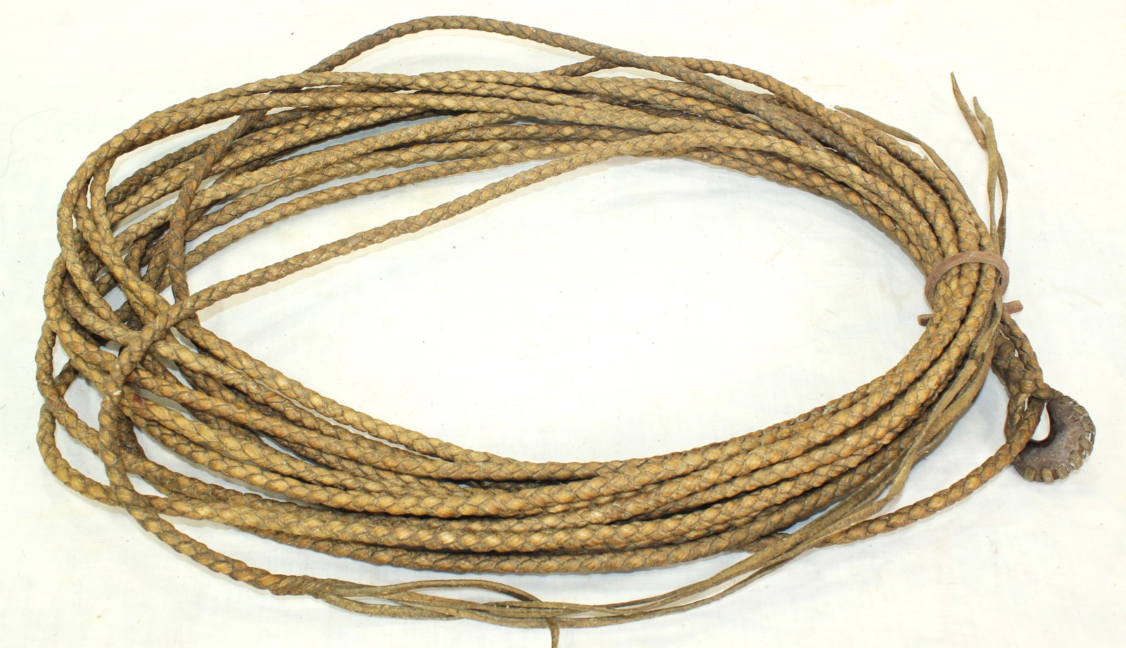 Rawhide Reata: An extra long 70ft. reata, beautifully made of braided for plait rawhide, finished by a great honda and extra long tails. Showing exceptional condition and color.
