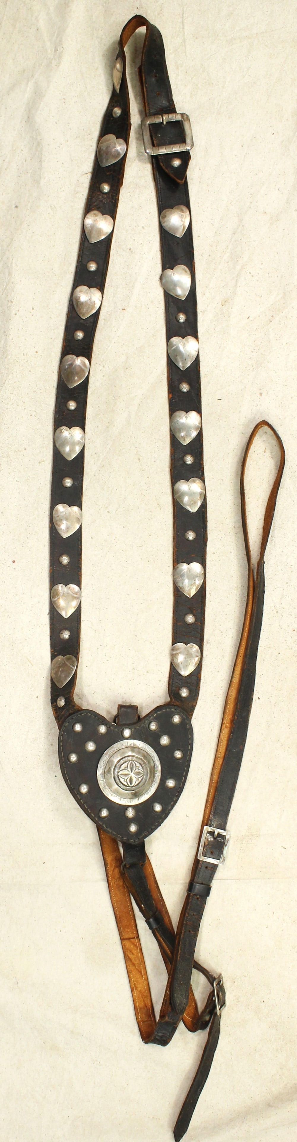 Early Silver Martingale: A finely made 19th Century martingale with beautifully engraved center silver medallion, and chest straps lined with heart-shaped silver conchos. Showing terrific eye appeal.