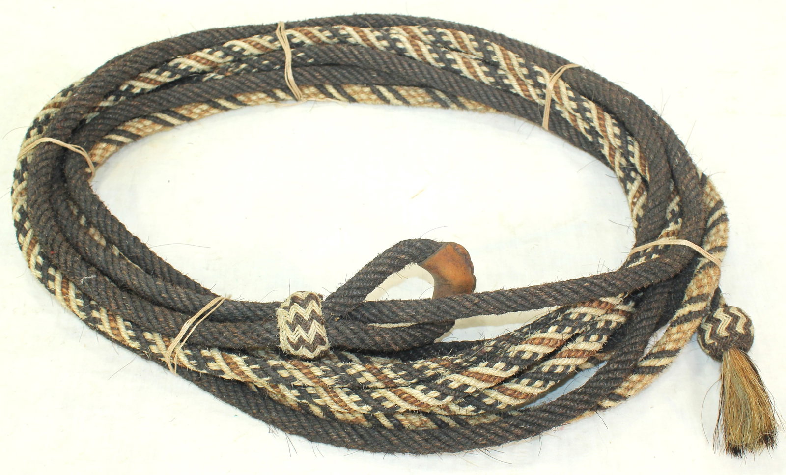 Fabulous Horsehair Rope: Fine 6 strand twist braided horsehair rope with beautifully done design of colors, measuring 33 feet long, and finished with a very attractive honda. Made for roping bulls. Very rare, one of only 5