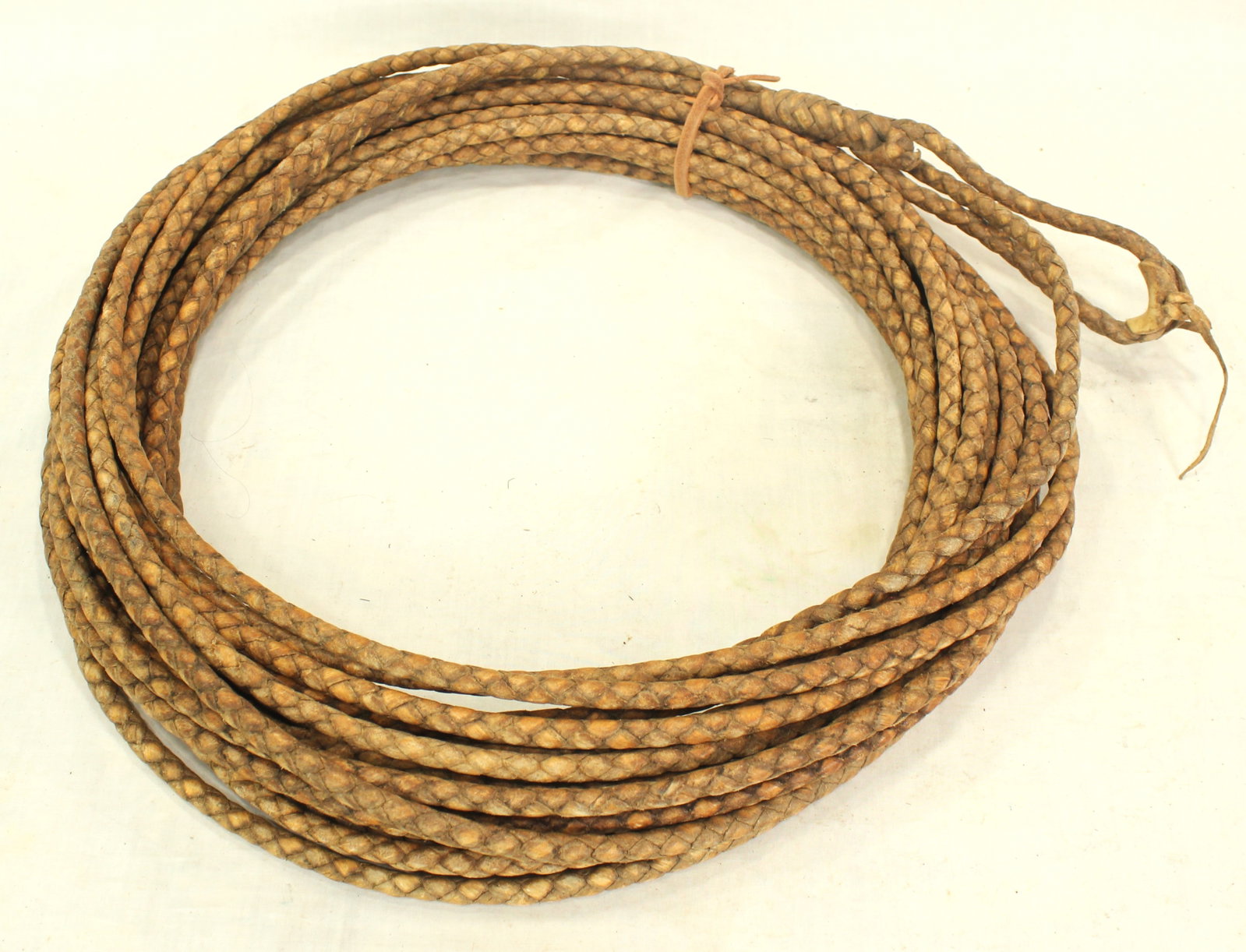 Rawhide Reata: Braided rawhide reata, tightly woven 4 plait craftsmanship, displaying great color and condition. Measuring 35 feet long.