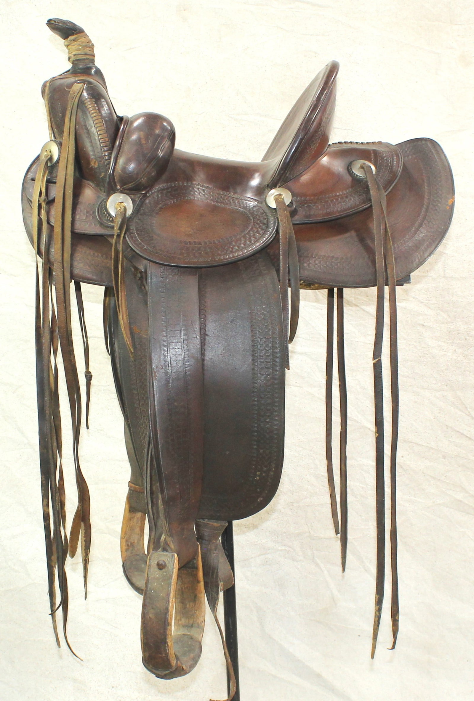 F.M. Stern Saddle: A ranchy looking early California slick-fork style saddle, with great appeal, having a 14” seat, tall 5” cantle, original bucking rolls, long saddle strings, wrapped horn, and ox bow