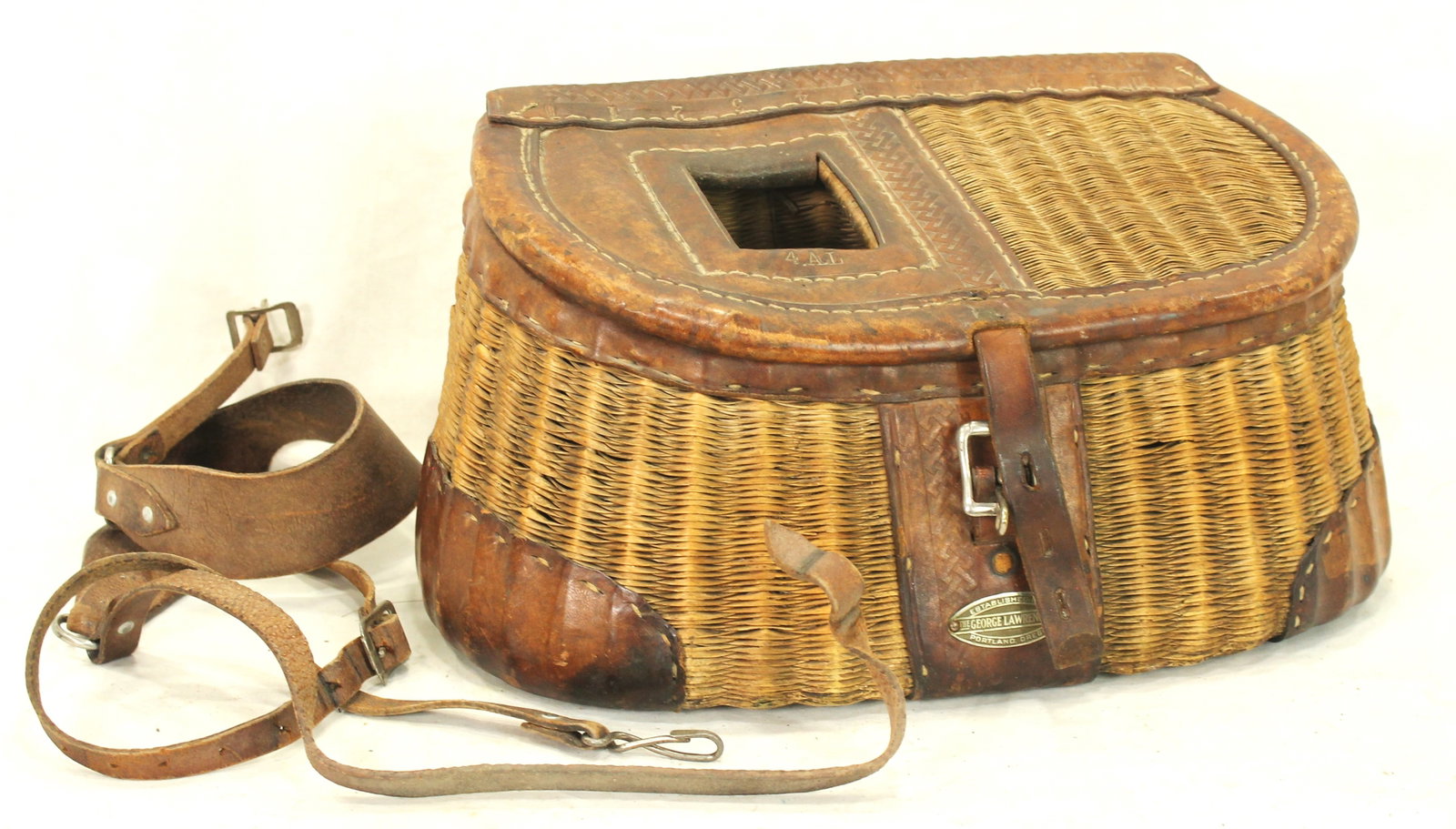 George Lawrence Fishing Creel: Fine woven creel bearing the label of renowned Portland outfitter George Lawrence, his equipment is highly regarded among collectors and represents some of the finest outdoor gear produced in the