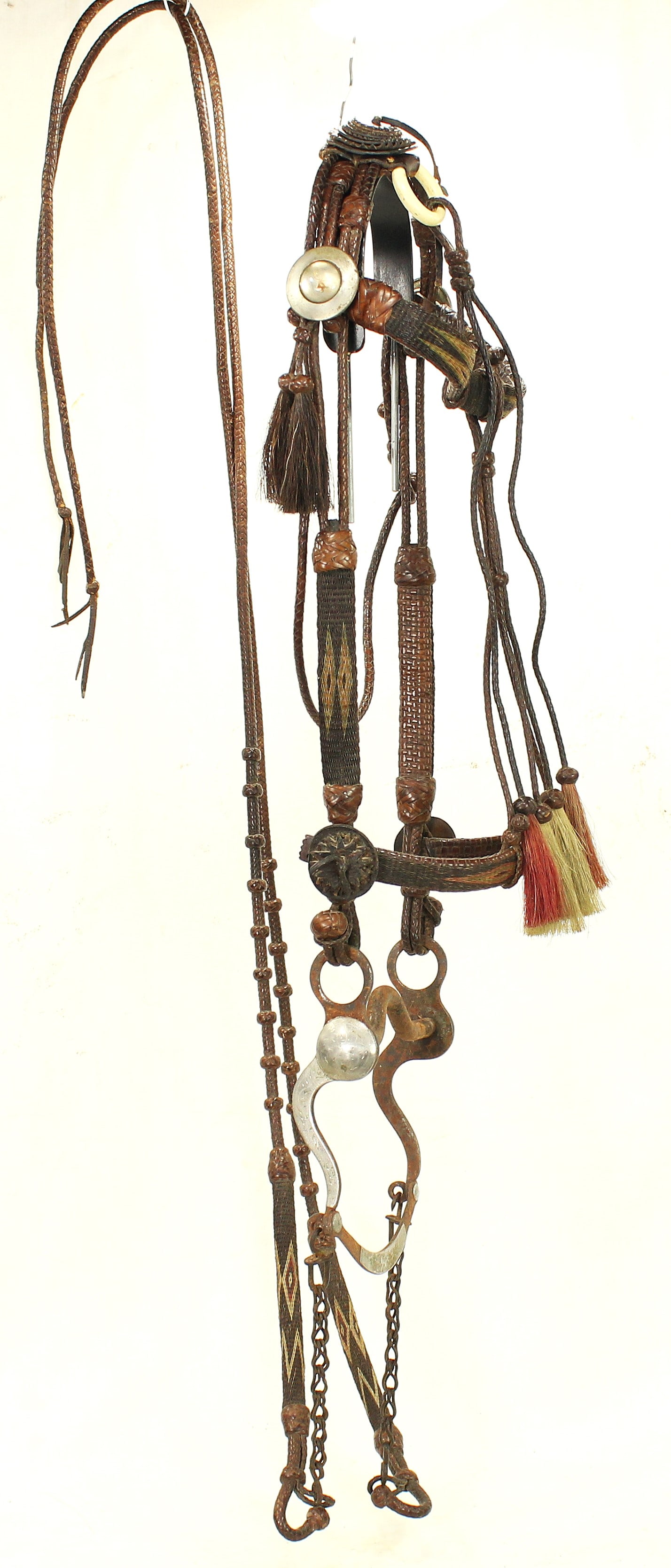 Wyoming Prison Horsehair Bridle: Finely executed braided horsehair bridle with finely incorporated braided leather, decorative knots and traditional Wyoming construction, with a scarce black background, great braided reins, and