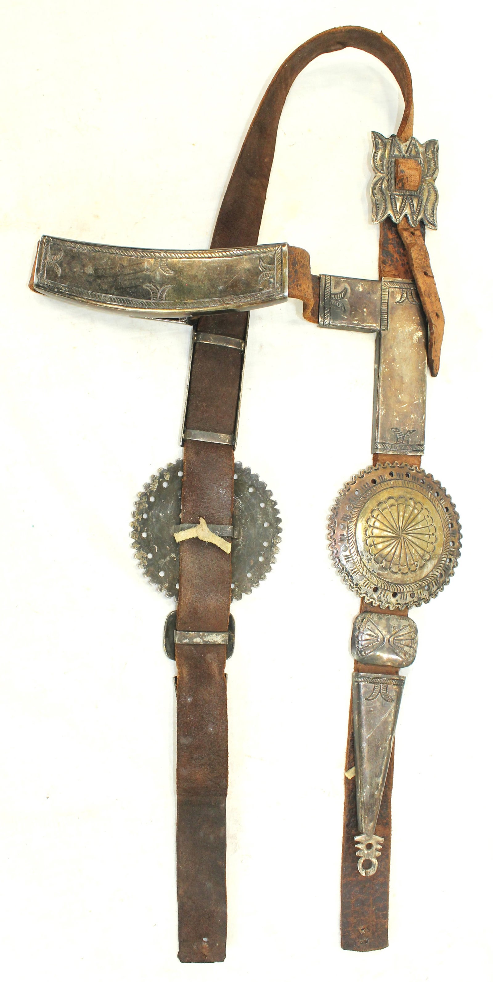 Navajo Silver Bridle: Fabulous early silver mounted Native American headstall, with pleasing original leather, with masterfully crafted silverwork, that includes the buckle, cheek tips, and is highlighted by the cheek