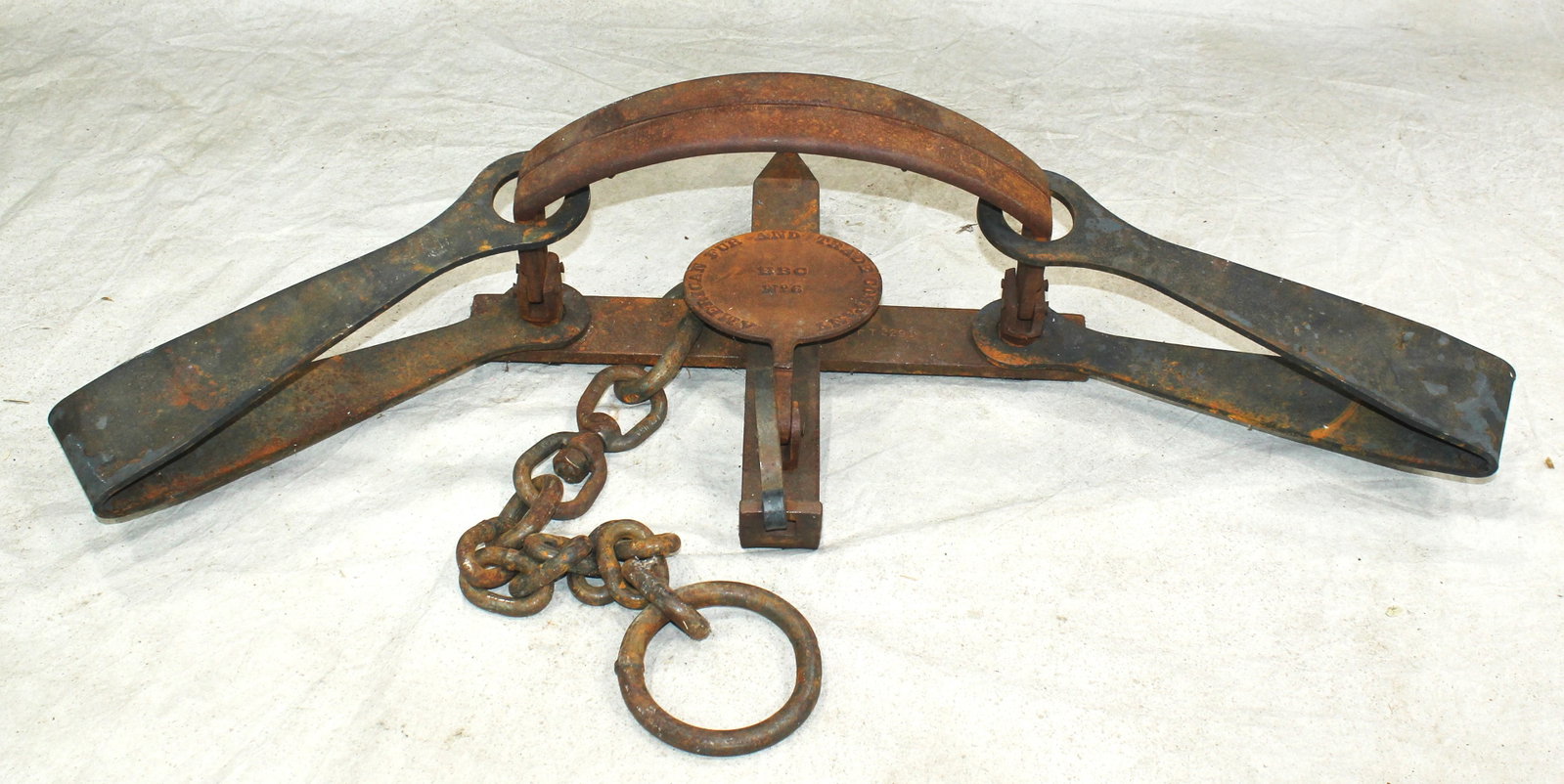 American Fur Co. Bear Trap: Massive iron bear trap retaining original chain and ring. A hard to find #6, with clear pan markings. In very good condition.
