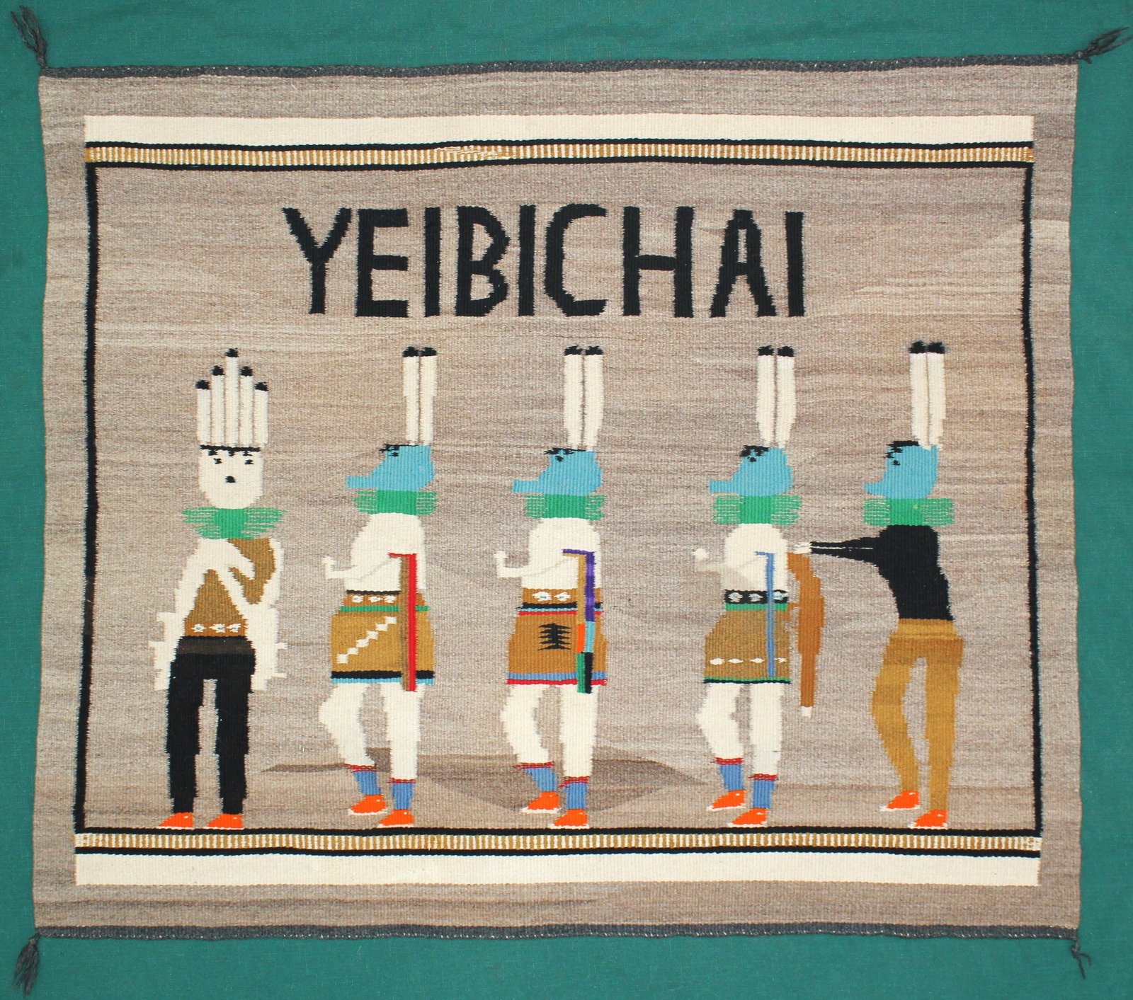 Unusual Native American Yei Weaving: A pleasing Yei pattern weaving with great colorful figures and the word "Yeibchai" woven into it. An exceptional hand woven piece with excellent condition. Measuring 39”x 33”.