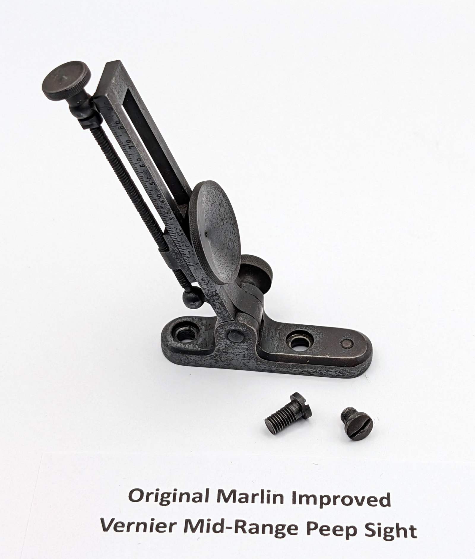 Marlin Vernier Mid-Range Tang Sight: A rare and highly desirable rear tang sight for a Marlin rifle, with adjustable eye cup and complete with mounting screws. In exceptional condition.
