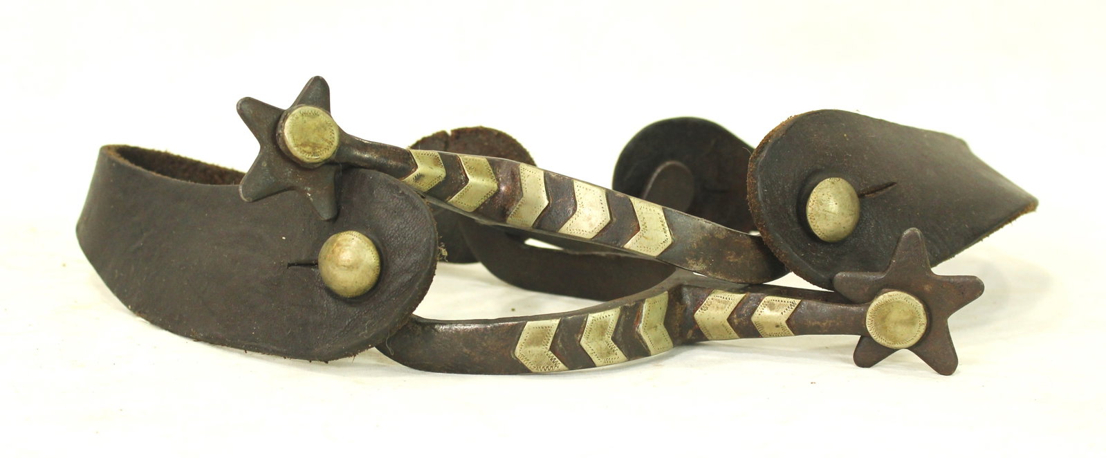 McChesney Silver Spurs: An uncommon pair of double mounted McChesney's with silver chevroned heelbands, and diamond offsides.