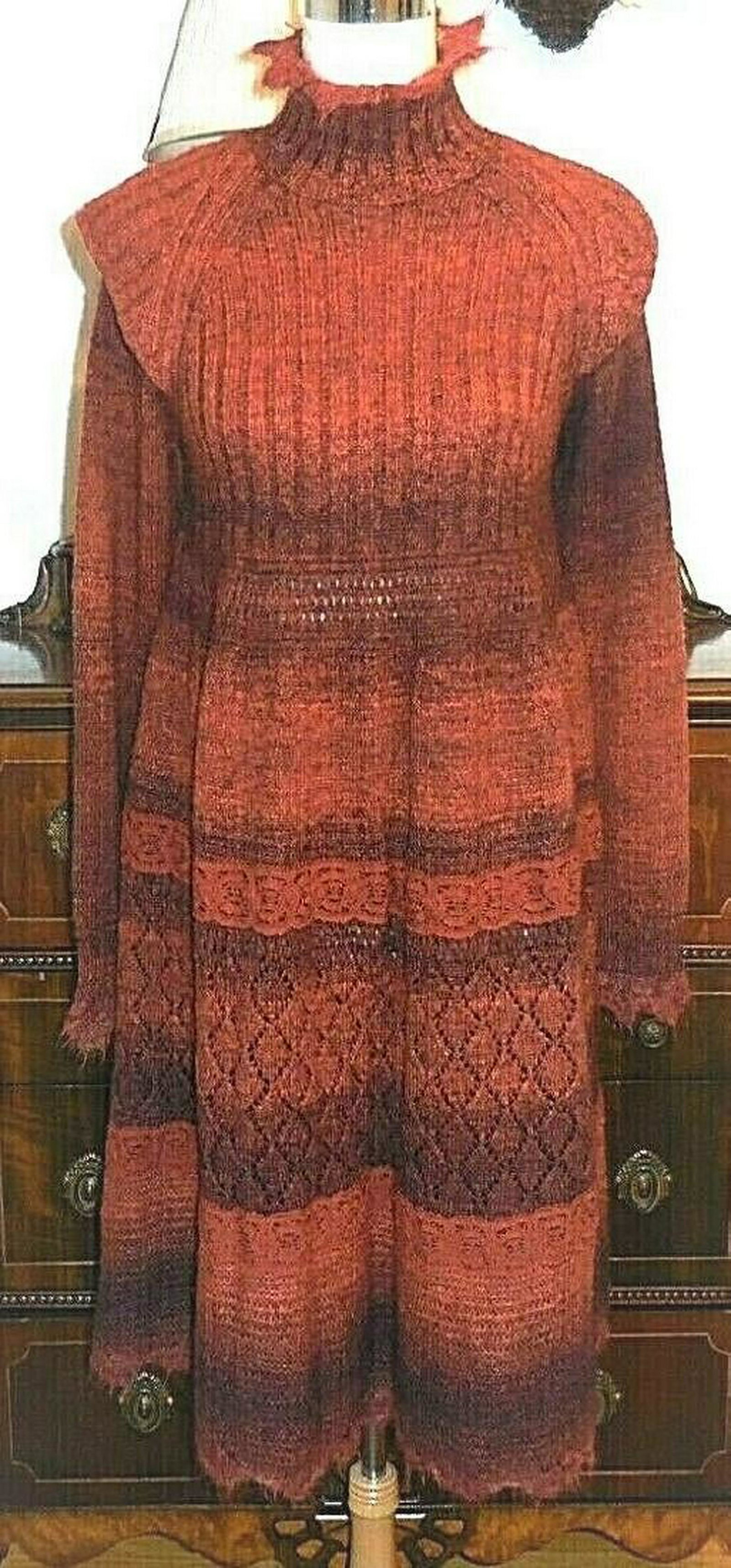 Jean Paul Gaultier high neck sweater dress: Here is a Jean Paul Gaultier sweater dress sz L. It is in a burnt orange with purple highlighting and has lace inserts in bands across the body of the dress. It is in an acrylic blend and is not lined