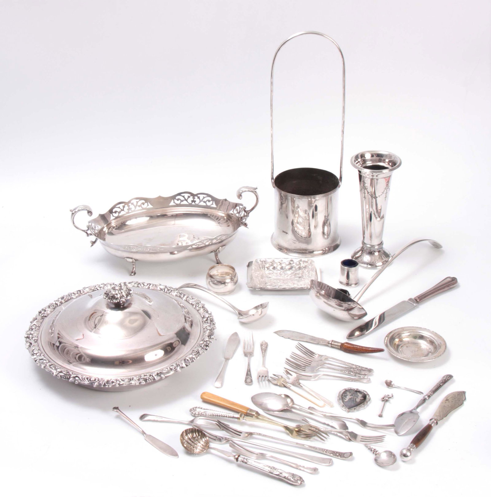 A COLLECTION OF SILVER PLATED WARES comprising A l: A COLLECTION OF SILVER PLATED WARES comprising A large circular divided HORS DE OEURVE DISH AND COVER with cast leaf work and fruiting vine border A WINE BOTTLE COASTER, A LARGE OVAL TWO HANDLED FRUIT
