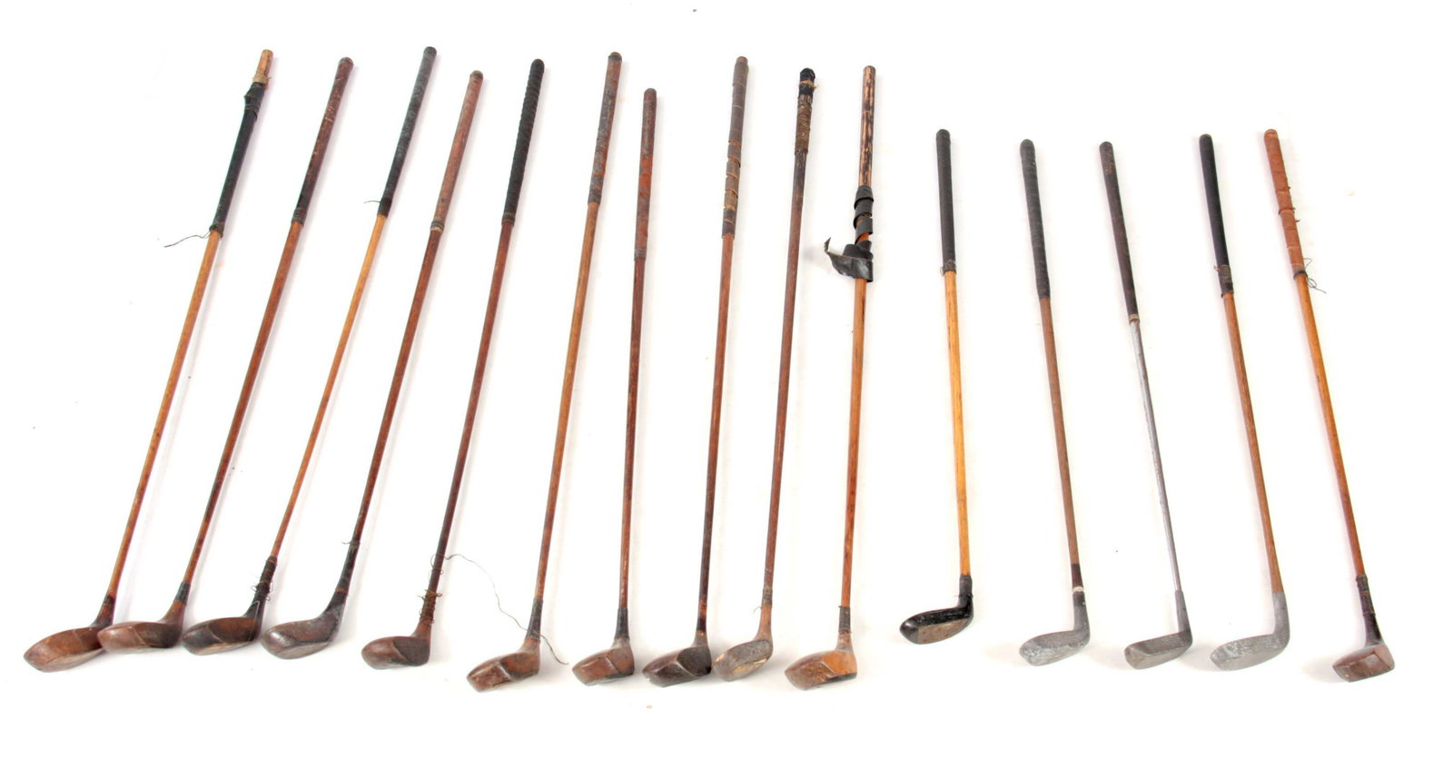 A SELECTION OF 15 ANTIQUE GOLF CLUBS comprising 11: A SELECTION OF 15 ANTIQUE GOLF CLUBS comprising 11 drivers and 4 putters including a Forgan St. Andrews putter, the New Mills RBB model putter and a Braid Mills 101 model putter.