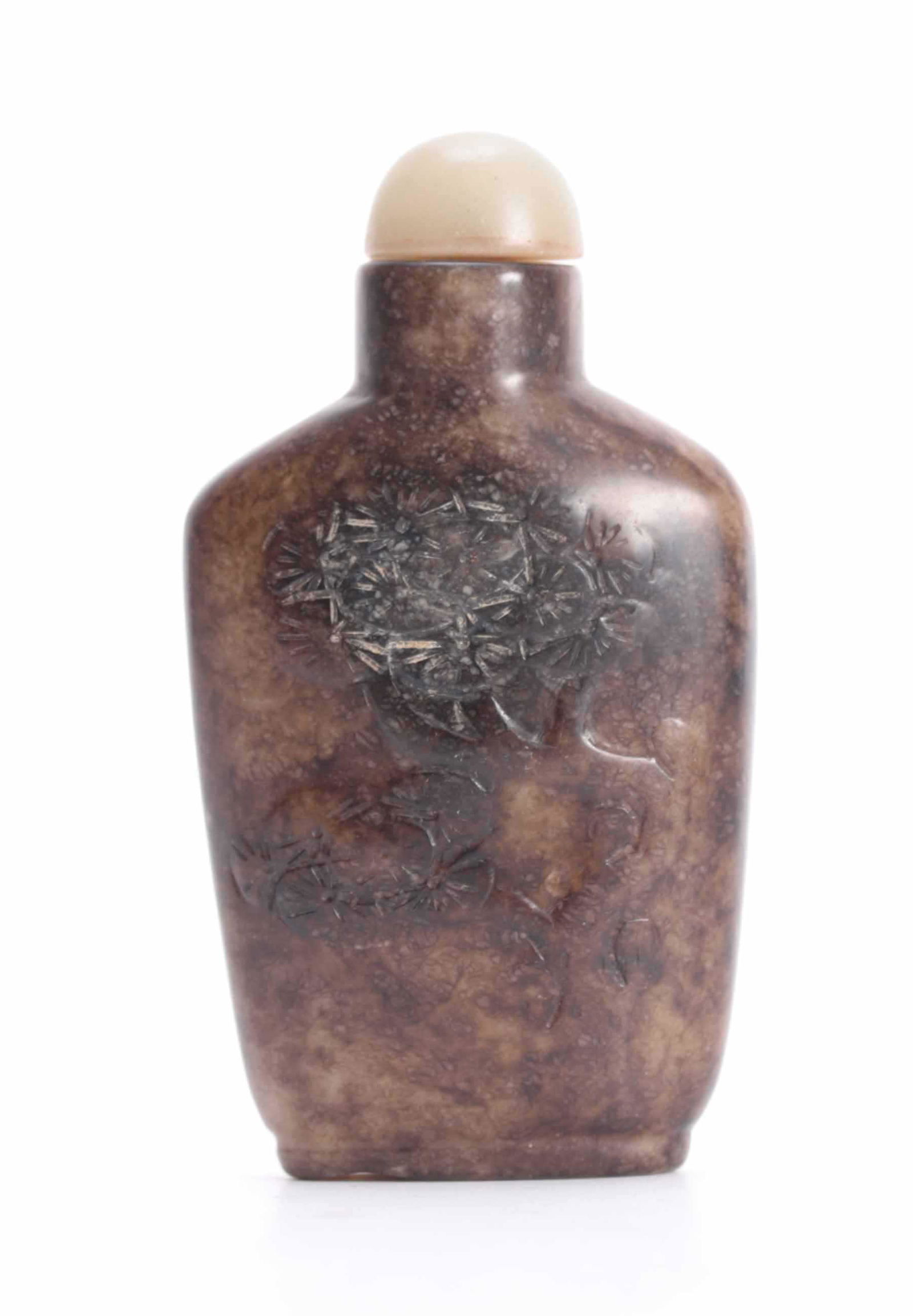 A CHINESE BROWN AND GREEN JADE SNUFF BOTTLE with domed: A CHINESE BROWN AND GREEN JADE SNUFF BOTTLE with domed stopper and decorated with flowering trees 7.5cm high.
